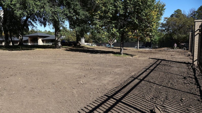 Freshly smoothed dirt rests behind a fence outside the North Dakota governor’s residence in...