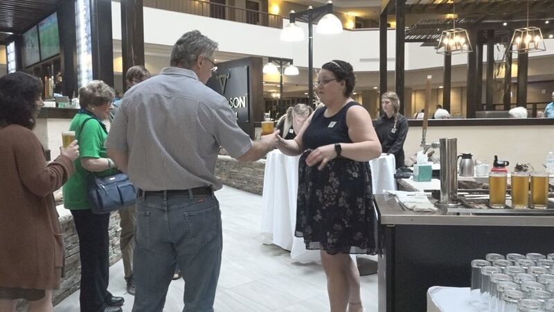 A man takes a complimentary beer at the Father's Day Brunch at Holiday Inn by Rushmore Plaza...
