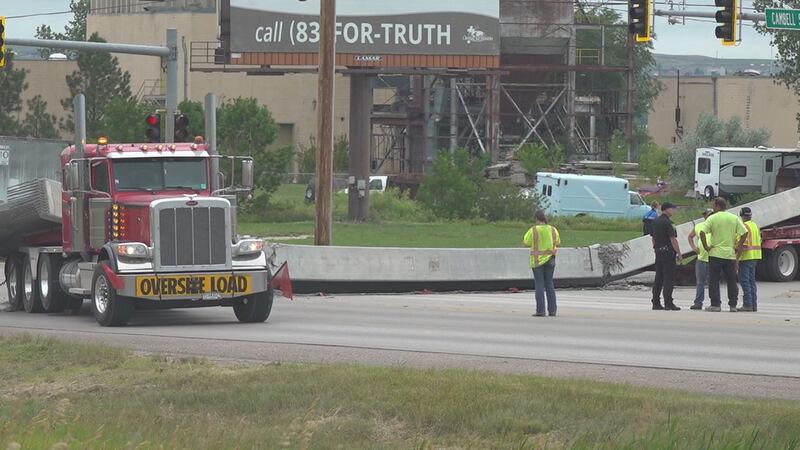 The truck dropped the concrete beam in the middle of the intersection.